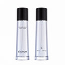 two bottles of a clear liquid, possibly a toner or facial cleanser, with black caps and branding.