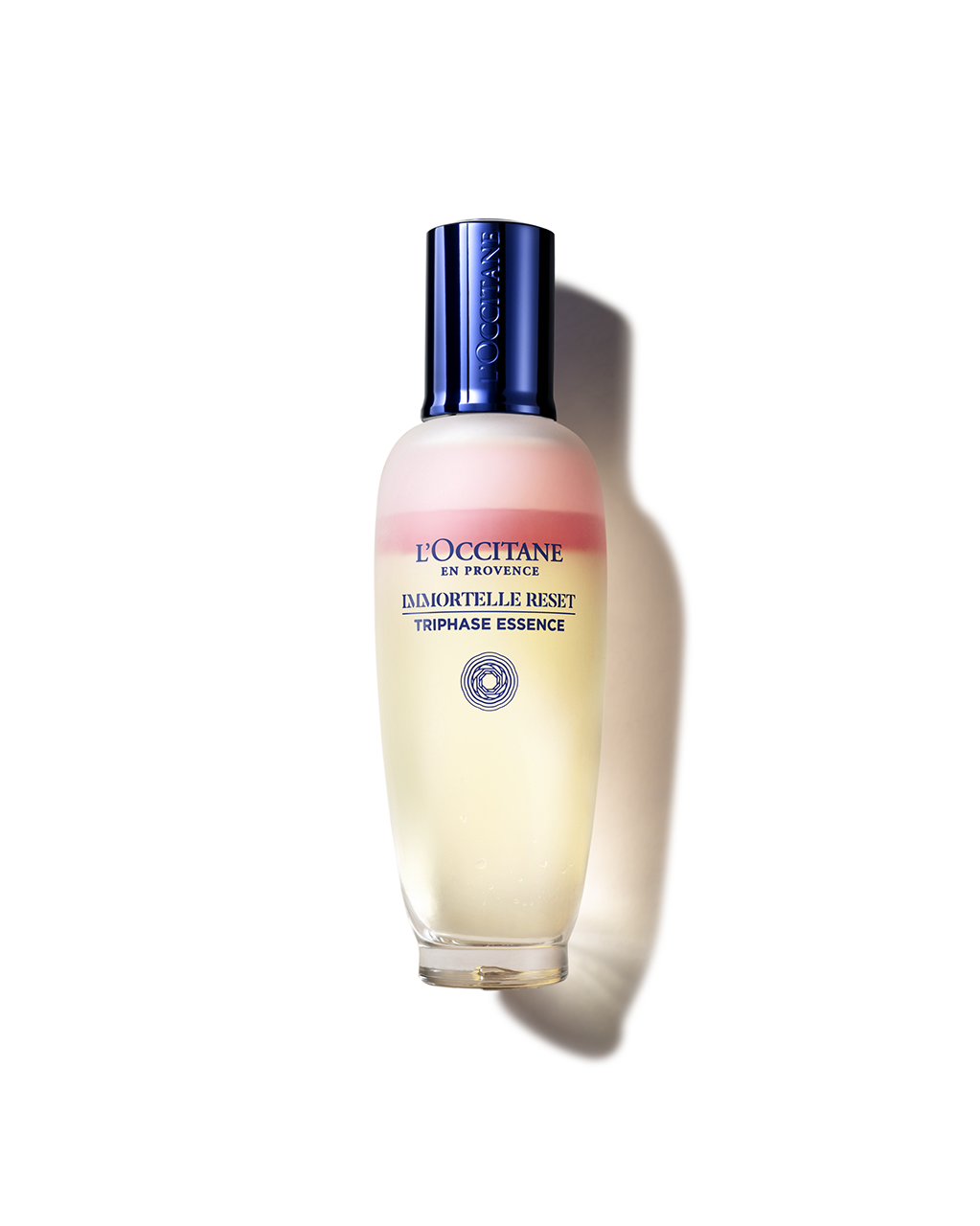 A bottle of L'Occ Tannerne en Provence, a liquid foundation with a yellow and pink gradient, and a blue cap.