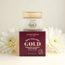 a jar of Lanocreme Gold Premium Placenta Face Cream, with a maroon box displaying the product name and details. The product is surrounded by white flowers, creating a visually appealing and elegant presentation.