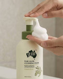A person's hands are applying a white, foamy substance to a bottle of "Pure Glow Cleansing Foam" with a green cap.
