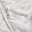 a close-up view of a white label with text and logos, likely associated with a wool quilt product.