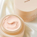 Two jars of skincare product with a light pink color, one jar is open and the other is closed.