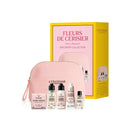a collection of beauty products from the L'Occitane brand, including a pink makeup bag, a pink travel bag, and various bottles of skincare and perfume products.