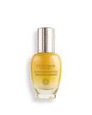 A bottle of L'Occitane Immortelle Divine Serum Pro-Fermété, a skincare product, against a black background.