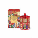 a red tin can with a Christmas-themed design, placed next to a box with a similar design and text.