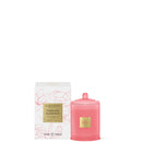a pink candle and its packaging, both with a floral design.
