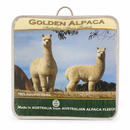 two alpacas standing in a field, with a focus on their fluffy, white coats.