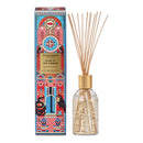 a glass diffuser with a gold-colored cap and a box with a colorful, ornate design.