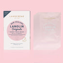 a set of 5 packs of Lanolin Origins Sheet Face Mask with Vitamin E, along with a box of the same product.