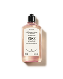 A bottle of L'Occitane en Provence Rose perfume shower gel, with a black cap and a pinkish-orange liquid inside.