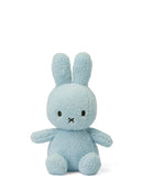 A light blue plush bunny toy with large ears and a small black mouth.