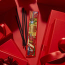 a red box with a colorful illustration and text, surrounded by red gift boxes and black straws on a red background.