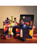 A collection of various beauty products, including bottles and jars, arranged in a decorative box with a floral pattern.