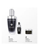 three Lancome beauty products: a Genifique Ultimate Serum 50ml bottle, a Genifique Genifique dropper bottle, and a Lancome Genifique Eye Cream 5ml jar.